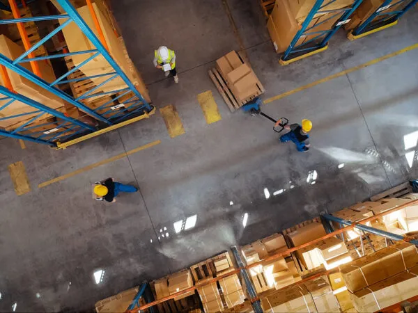 Top-Down View: In Warehouse People Working, Forklift Truck Operator Lifts Pallet with Cardboard Box. Logistics, Distribution Center with Products Ready for Global Shipment, Customer Delivery