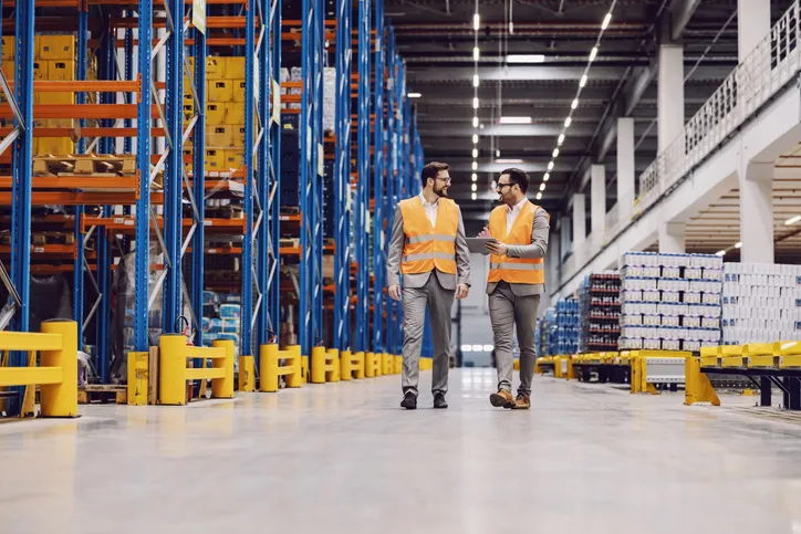 Storage owner with tablet in hands showing around storage to his partner.